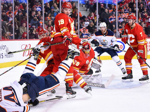 CALGARY, AB - JANUARY 11: Calgary Flames Right Wing Matthew Tkachuk (19) bodychecks Edmonton Oilers Right Wing Zack Kassian (44) to the ice during the first period of an NHL game where the Calgary Flames hosted the Edmonton Oilers on January 11, 2020, at the Scotiabank Saddledome in Calgary, AB.
