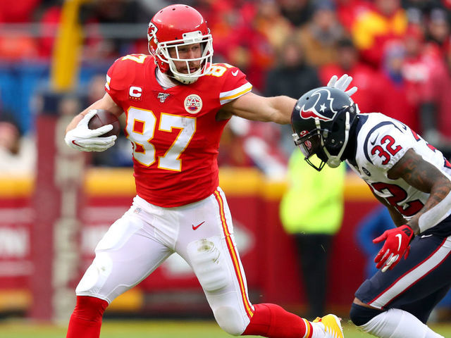 KANSAS CITY, MISSOURI - JANUARY 12: Travis Kelce #87 of the Kansas City Chiefs is pursued by Lonnie Johnson Jr. #32 of the Houston Texans during the first quarter in the AFC Divisional playoff game at Arrowhead Stadium on January 12, 2020 in Kansas City, Missouri.