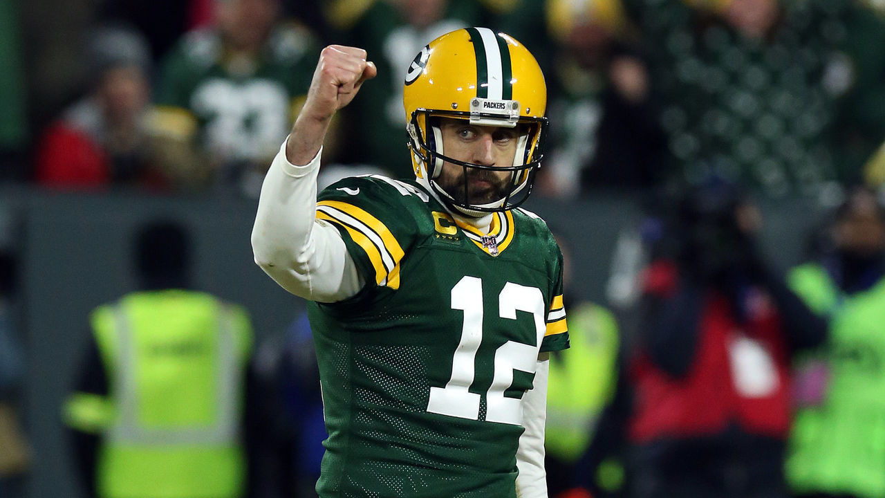 GREEN BAY, WISCONSIN - JANUARY 12: Quarterback Aaron Rodgers #12 of the Green Bay Packers celebrate a touchdown against the Seattle Seahawks in the second quarter of the NFC Divisional Playoff game at Lambeau Field on January 12, 2020 in Green Bay, Wisconsin.