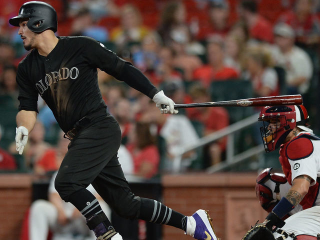 ST. LOUIS, MO - AUGUST 23: Nolan Arenado #28 of the Colorado Rockies hits a single in the ninth inning against the St. Louis Cardinals at Busch Stadium on August 23, 2019 in St. Louis, Missouri. Teams are wearing special color schemed uniforms with players choosing nicknames to display for Players' Weekend.