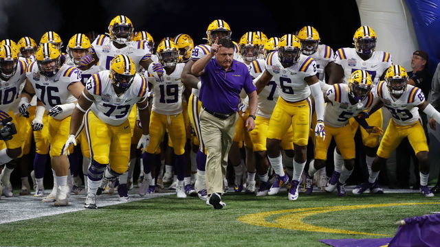 ATLANTA, GEORGIA - DECEMBER 28: Head coach Ed Orgeron of the LSU Tigers and team run onto the to take on the Oklahoma Sooners in the Chick-fil-A Peach Bowl at Mercedes-Benz Stadium on December 28, 2019 in Atlanta, Georgia.