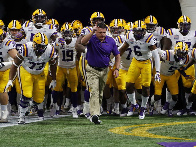ATLANTA, GEORGIA - DECEMBER 28: Head coach Ed Orgeron of the LSU Tigers and team run onto the to take on the Oklahoma Sooners in the Chick-fil-A Peach Bowl at Mercedes-Benz Stadium on December 28, 2019 in Atlanta, Georgia.
