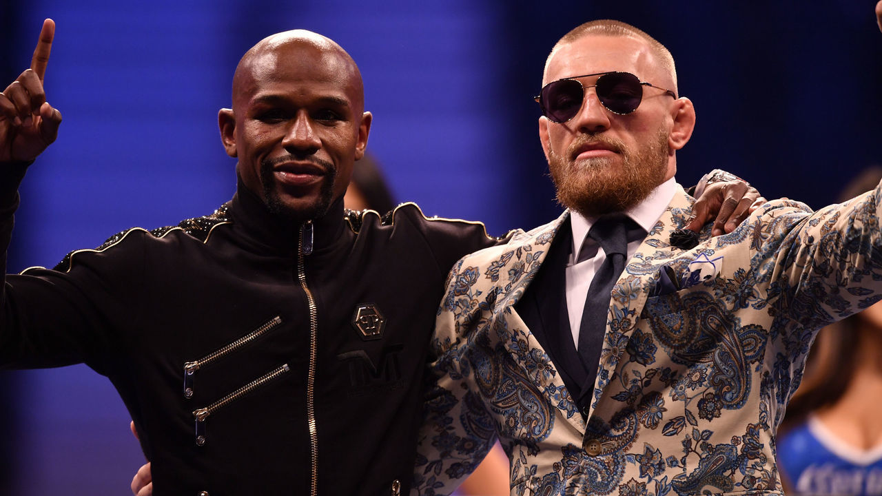 LAS VEGAS, NV - AUGUST 25: (L-R) Floyd Mayweather Jr. and Conor McGregor pose for pictures during a news conference after Mayweather's 10th-round TKO victory in their super welterweight boxing match on August 26, 2017 at T-Mobile Arena in Las Vegas, Nevada.