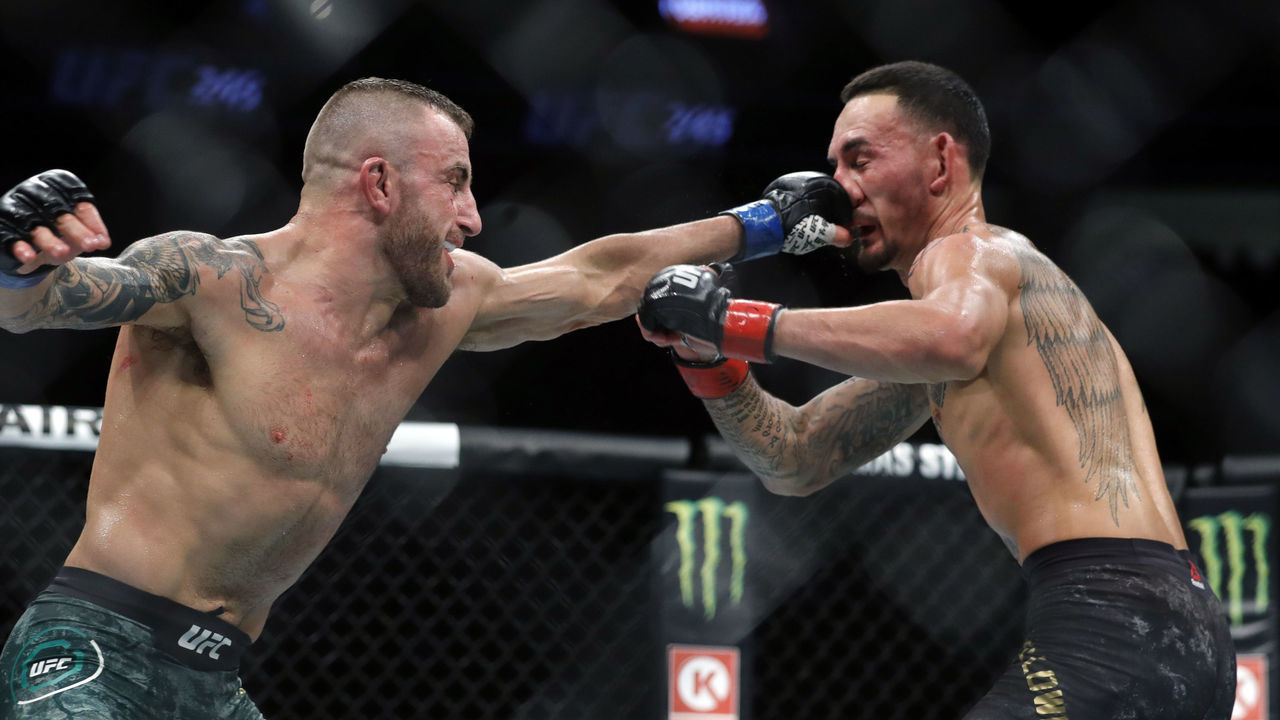 LAS VEGAS, NEVADA - DECEMBER 14: Alexander Volkanovski (L) punches UFC featherweight champion Max Holloway in their title fight during UFC 245 at T-Mobile Arena on December 14, 2019 in Las Vegas, Nevada. Volkanovski took the title by unanimous decision.