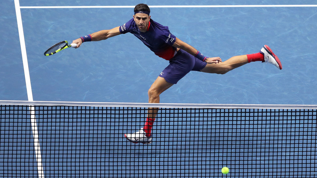 LONDON, ENGLAND - NOVEMBER 13: Robert Farah, playing partner of Juan Sebastian Cabal of Colombia stretches to play a forehand in their doubles match against Jean-Julien Rojer of The Netherlands and Horia Tecau of Romania during Day Four of the Nitto ATP Finals at The O2 Arena on November 13, 2019 in London, England.