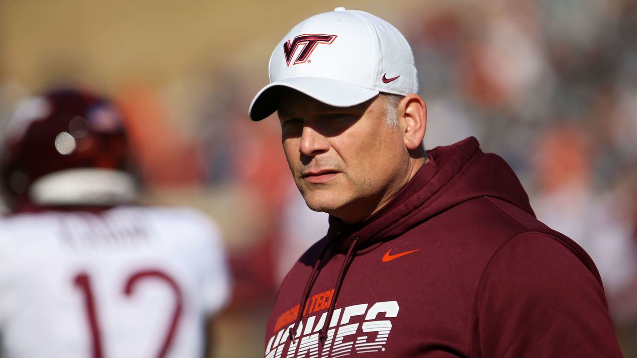 CHARLOTTESVILLE, VA - NOVEMBER 29: Head coach Justin Fuente of the Virginia Tech Hokies watches his team warm up before the start of a game against the Virginia Cavaliers at Scott Stadium on November 29, 2019 in Charlottesville, Virginia.