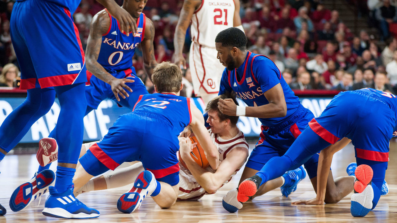 NORMAN, OK - JANUARY 14: Oklahoma (12) Austin Reaves keeping the ball away from Kansas players during the Oklahoma Sooners game versus the Kansas Jayhawks on January 14, 2020 at Lloyd Noble Center in Norman, OK.