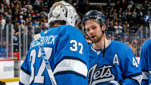 WINNIPEG, MB - JANUARY 14: Goaltender Connor Hellebuyck #37 of the Winnipeg Jets gets congratulated by teammate Josh Morrissey #44 following a 4-0 shutout over the Vancouver Canucks at the Bell MTS Place on January 14, 2020 in Winnipeg, Manitoba, Canada.