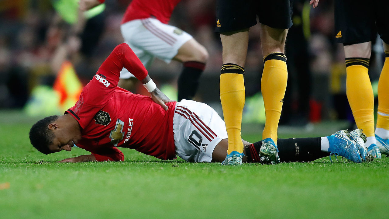 Manchester United's Marcus Rashford lies in pain after picking up a back injury during the FA Cup third round replay match at Old Trafford, Manchester.