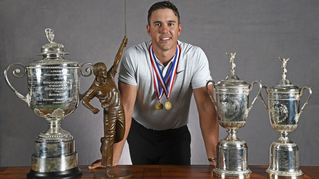 JUPITER, FL - OCTOBER 09: Brooks Koepka poses with the Wanamaker trophy, Player of the Year trophy and the US Open trophies during the Player of the Year ceremony at The Bear's Club on October 9, 2018 in Jupiter, Florida.