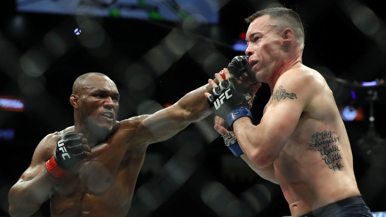 LAS VEGAS, NEVADA - DECEMBER 14: UFC welterweight champion Kamaru Usman (L) punches Colby Covington in their welterweight title fight during UFC 245 at T-Mobile Arena on December 14, 2019 in Las Vegas, Nevada. Usman retained his title with a fifth-round TKO.