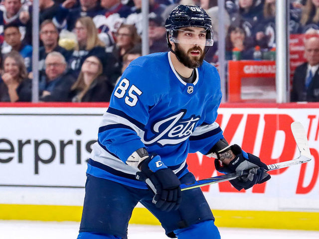 WINNIPEG, MB - JANUARY 14: Mathieu Perreault #85 of the Winnipeg Jets keeps an eye on the play during third period action against the Vancouver Canucks at the Bell MTS Place on January 14, 2020 in Winnipeg, Manitoba, Canada.