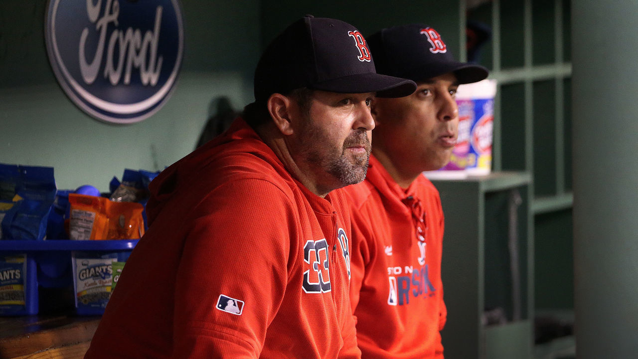 BOSTON - SEPTEMBER 27: Boston Red Sox special assistant Jason Varitek chats with Boston Red Sox manager Alex Cora (20) in the dugout. The Boston Red Sox host the Baltimore Orioles in a regular season MLB baseball game at Fenway Park in Boston on Sep. 27, 2019.