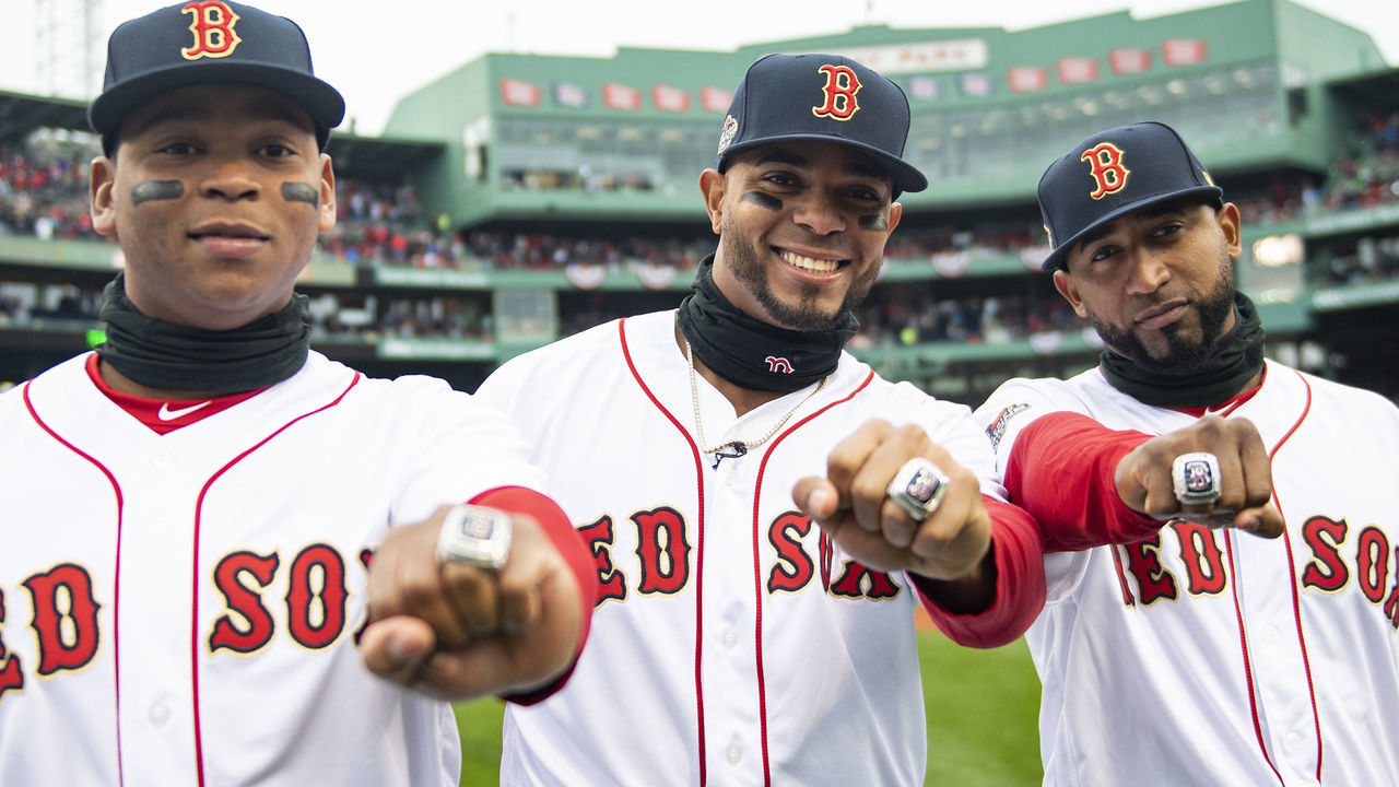 BOSTON, MA - APRIL 9: Rafael Devers #11, Xander Bogaerts #2, and Eduardo Nunez #36 of the Boston Red Sox pose with their rings during a 2018 World Series championship ring ceremony before the Opening Day game against the Toronto Blue Jays on April 9, 2019 at Fenway Park in Boston, Massachusetts.