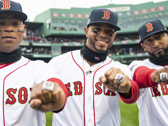 BOSTON, MA - APRIL 9: Rafael Devers #11, Xander Bogaerts #2, and Eduardo Nunez #36 of the Boston Red Sox pose with their rings during a 2018 World Series championship ring ceremony before the Opening Day game against the Toronto Blue Jays on April 9, 2019 at Fenway Park in Boston, Massachusetts.