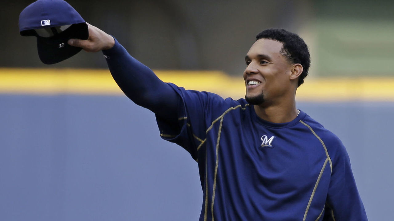 MILWAUKEE, WI - JULY 30: Carlos Gomez #27 of the Milwaukee Brewers tips his hat with teammates before their game against the Chicago Cubs at Miller Park on July 30, 2015 in Milwaukee, Wisconsin.