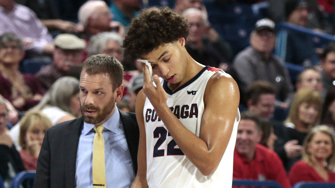 SPOKANE, WASHINGTON - NOVEMBER 12: An injured Anton Watson #22 of the Gonzaga Bulldogs is escorted off of the court in the second half against the North Dakota Fighting Hawks at McCarthey Athletic Center on November 12, 2019 in Spokane, Washington. Gonzaga defeats North Dakota 97-66.