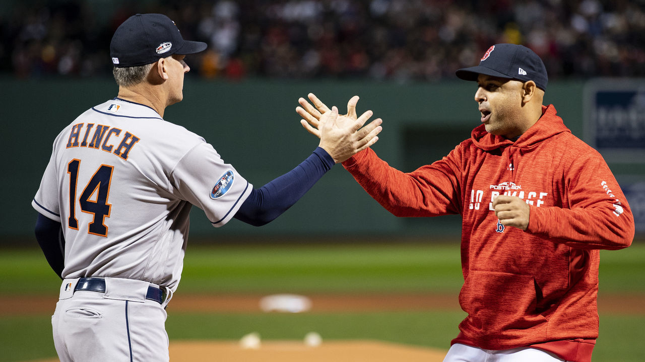 BOSTON, MA - OCTOBER 13: Manager Alex Cora of the Boston Red Sox high fives manager A.J. Hinch of the Houston Astros before game one of the American League Championship Series on October 13, 2018 at Fenway Park in Boston, Massachusetts.