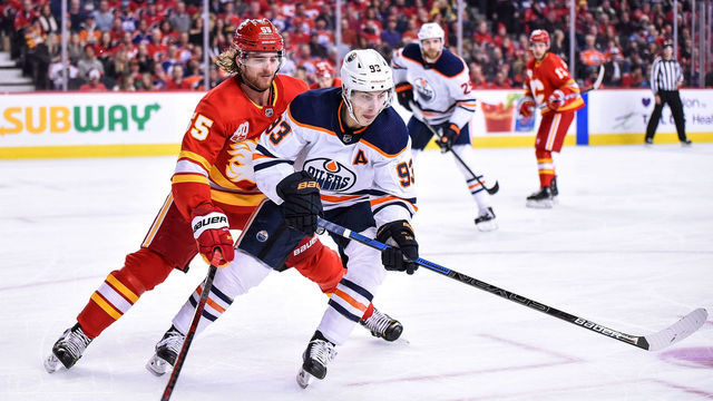 CALGARY, AB - JANUARY 11: Calgary Flames Defenceman Noah Hanifin (55) and Edmonton Oilers Left Wing Ryan Nugent-Hopkins (93) skate after after the puck during the first period of an NHL game where the Calgary Flames hosted the Edmonton Oilers on January 11, 2020, at the Scotiabank Saddledome in Calgary, AB.