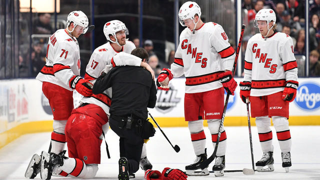 COLUMBUS, OH - JANUARY 16: Dougie Hamilton #19 of the Carolina Hurricanes is helped up by head athletic trainer Doug Bennett following a collision during the second period of a game against the Columbus Blue Jackets on January 16, 2020 at Nationwide Arena in Columbus, Ohio.