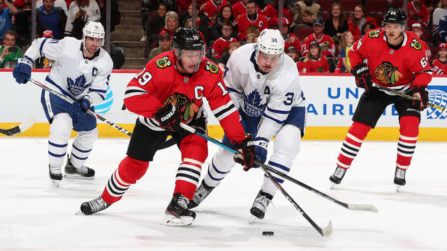 CHICAGO, IL - NOVEMBER 10: Jonathan Toews #19 of the Chicago Blackhawks and Auston Matthews #34 of the Toronto Maple Leafs battle for the puck in the third period at the United Center on November 10, 2019 in Chicago, Illinois.