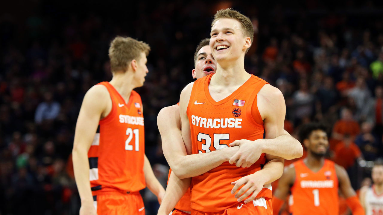 CHARLOTTESVILLE, VA - JANUARY 11: Joseph Girard III #11 hugs Buddy Boeheim #35 of the Syracuse Orange in overtime during a game against the Virginia Cavaliers at John Paul Jones Arena on January 11, 2020 in Charlottesville, Virginia.