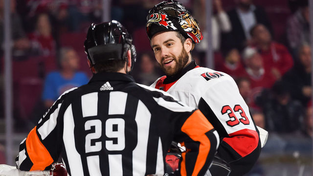 MONTREAL, QC - DECEMBER 15: Ottawa Senators goalie Mike McKenna (33) discusses with NHL referee Ian Walsh (29) during the Ottawa Senators versus the Montreal Canadiens game on December 15, 2018, at Bell Centre in Montreal, QC