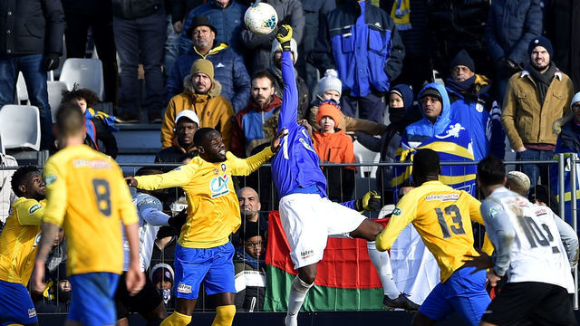 Saint-Pierroise's goalkeeper Ibrahim Dabo (C) stops the ball during the French cup football match between Epinal (SAS Epinal) and Saint-Pierroise (JS Saint-Pierroise) on January 18, 2020, at La Colombiere stadium in Epinal, northeastern France.