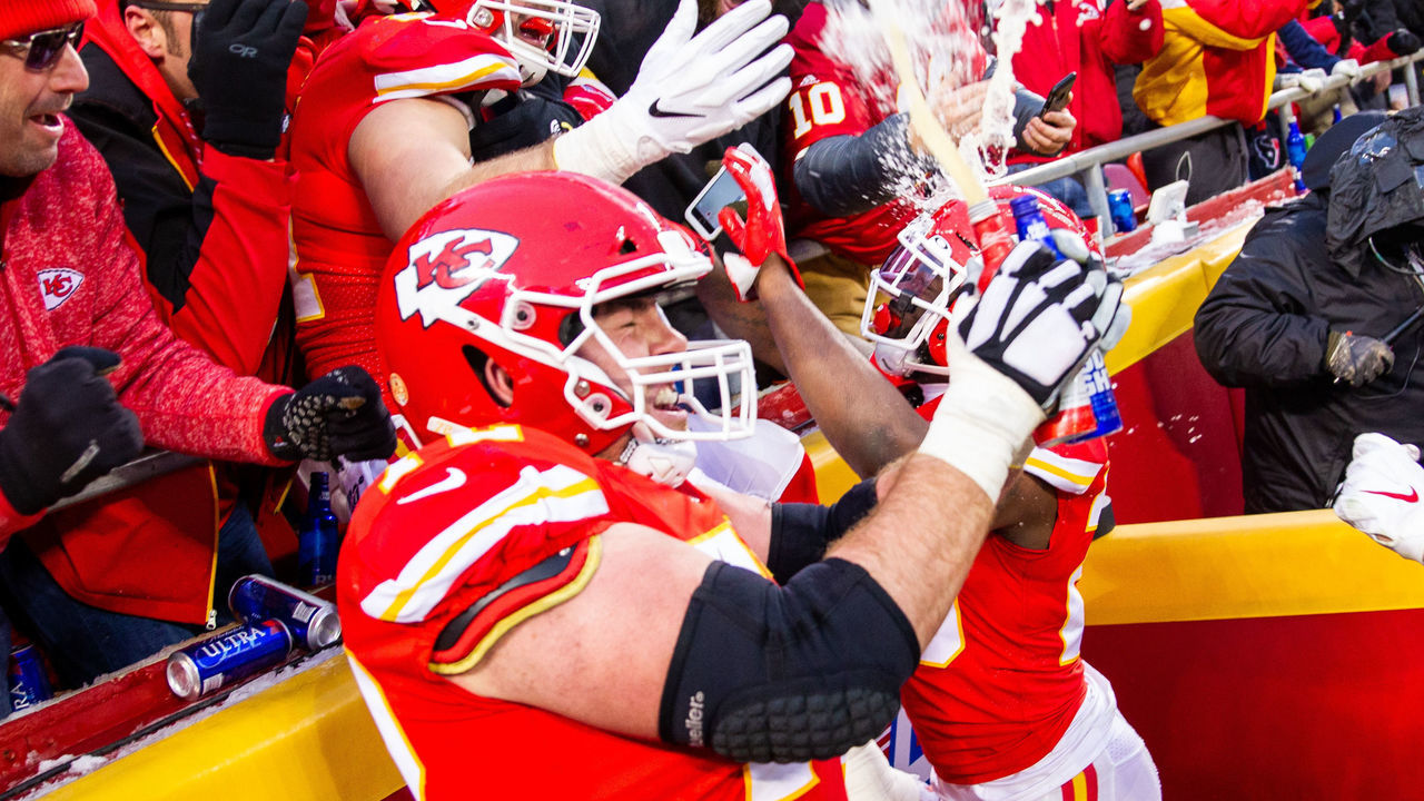 KANSAS CITY, MO - JANUARY 12: Kansas City Chiefs offensive tackle Eric Fisher (72) and Kansas City Chiefs running back Damien Williams (26) and Kansas City Chiefs tight end Blake Bell (81) celebrate with fans after a touchdown against the Houston Texans on January 12, 2019 at Arrowhead Stadium in Kansas City, Missouri.