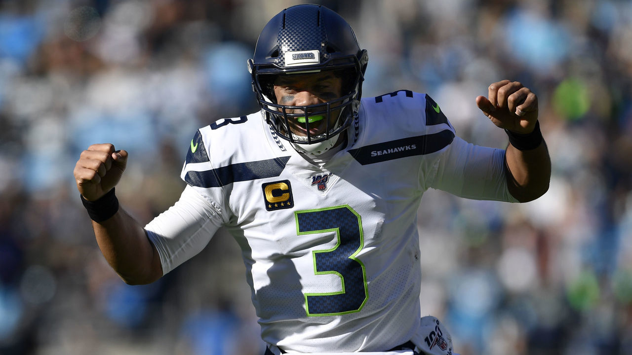 CHARLOTTE, NORTH CAROLINA - DECEMBER 15: Seattle Seahawks quarterback Russell Wilson #3 reacts to throwing a touchdown pass against Carolina Panthers in the first quarter at Bank of America Stadium on December 15, 2019 in Charlotte, North Carolina.