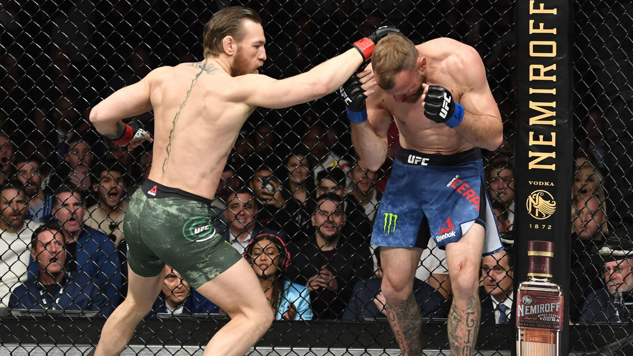 LAS VEGAS, NEVADA - JANUARY 18: (L-R) Conor McGregor of Ireland punches Donald Cerrone in their welterweight fight during the UFC 246 event at T-Mobile Arena on January 18, 2020 in Las Vegas, Nevada.
