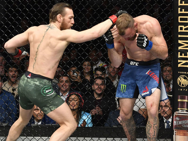 LAS VEGAS, NEVADA - JANUARY 18: (L-R) Conor McGregor of Ireland punches Donald Cerrone in their welterweight fight during the UFC 246 event at T-Mobile Arena on January 18, 2020 in Las Vegas, Nevada.