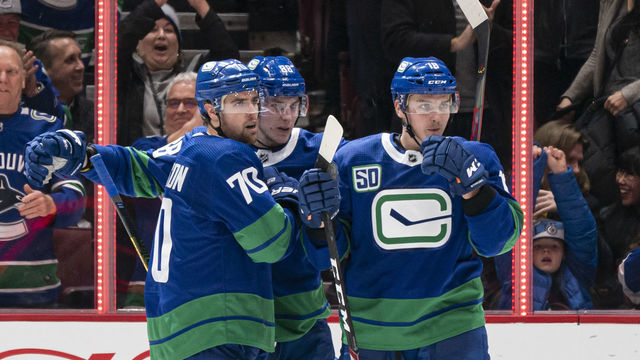 VANCOUVER, BC - JANUARY 18: Tanner Pearson #70 of the Vancouver Canucks celebrates with teammates Adam Gaudette #88 and Jake Virtanen #18 after scoring a goal against the San Jose Sharks in NHL action on January, 18, 2020 at Rogers Arena in Vancouver, British Columbia, Canada.