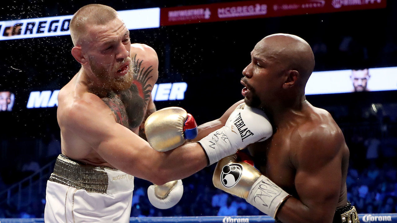 LAS VEGAS, NV - AUGUST 26: (R-L) Floyd Mayweather Jr. throws a punch at Conor McGregor during their super welterweight boxing match on August 26, 2017 at T-Mobile Arena in Las Vegas, Nevada.