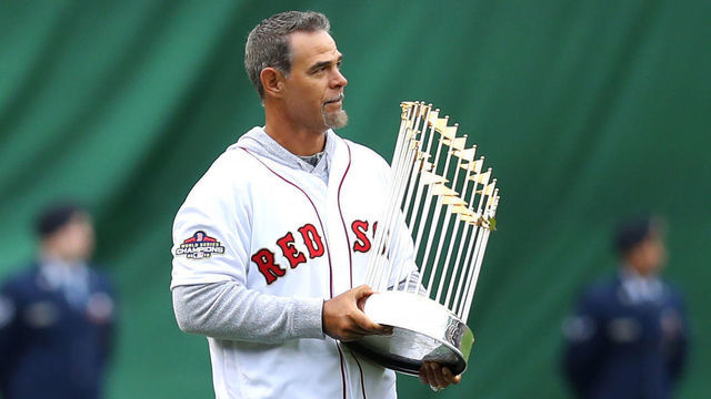 BOSTON, MASSACHUSETTS - APRIL 09: Former MLB player Mike Lowell walks on the field with the 2018 World Series Championship trophy before the home opener at Fenway Park on April 09, 2019 in Boston, Massachusetts.