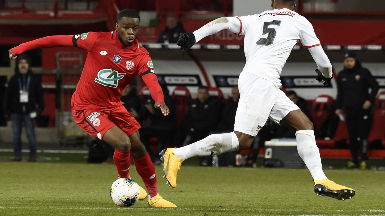 Dijon's English forward Stephy Mavididi (L) vies with Nimes' French defender Loick Landre (R) during the French Cup football match between Dijon (DFCO) and Nimes Olympique, at the Gaston Gerard stadium in Dijon on January 19, 2020.