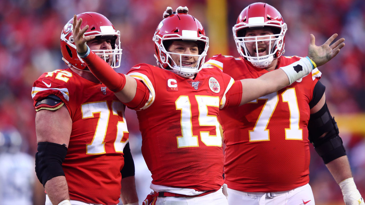 KANSAS CITY, MISSOURI - JANUARY 19: Patrick Mahomes #15 of the Kansas City Chiefs reacts with teammates Eric Fisher #72 and Mitchell Schwartz #71 after a fourth quarter touchdown pass against the Tennessee Titans in the AFC Championship Game at Arrowhead Stadium on January 19, 2020 in Kansas City, Missouri.