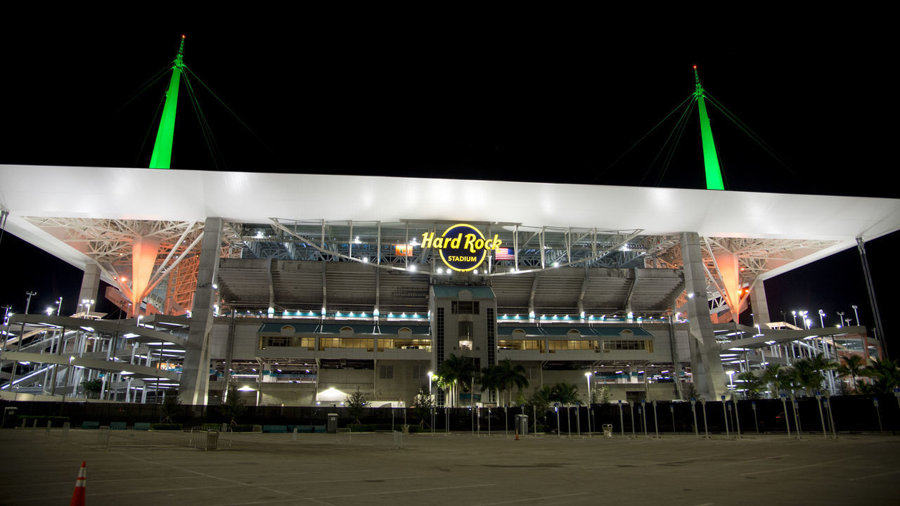 MIAMI GARDENS, FL - SEPTEMBER 08: Exterior view of the Hard Rock Stadium lit up with the green and orange colors of the University of Miami after the college football game between the Savannah State Tigers and the University of Miami Hurricanes on September 8, 2018 at the Hard Rock Stadium in Miami Gardens, FL.