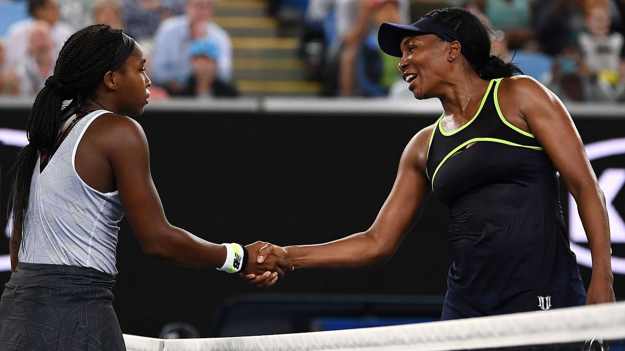 MELBOURNE, AUSTRALIA - JANUARY 20: Coco Gauff of the United States of America and Venus Williams of the United States of America embrace at the net following their Women's Singles first round match on day one of the 2020 Australian Open at Melbourne Park on January 20, 2020 in Melbourne, Australia.