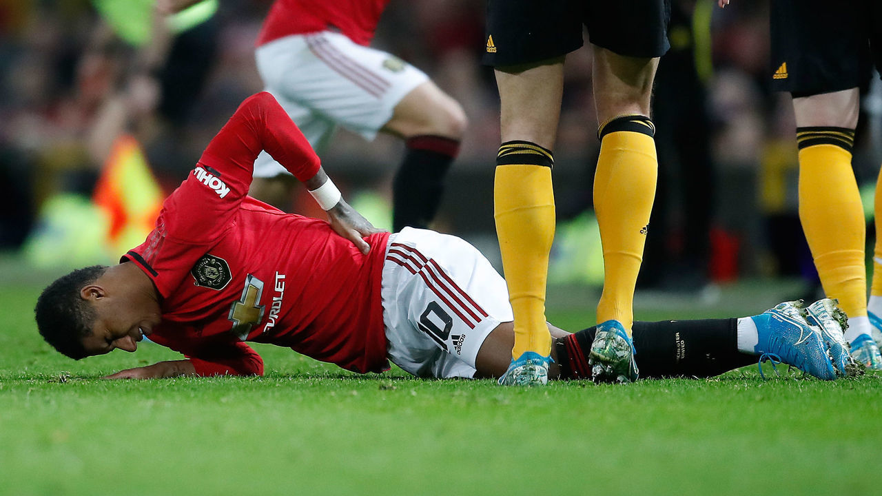 Manchester United's Marcus Rashford lies in pain after picking up a back injury during the FA Cup third round replay match at Old Trafford, Manchester.