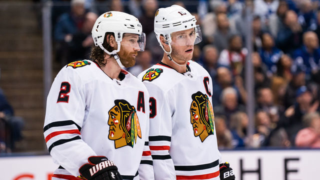 TORONTO, ON - JANUARY 18: Duncan Keith #2 of the Chicago Blackhawks talks to teammate Jonathan Toews #19 at an NHL game against the Toronto Maple Leafs during the second period at the Scotiabank Arena on January 18, 2020 in Toronto, Ontario, Canada.