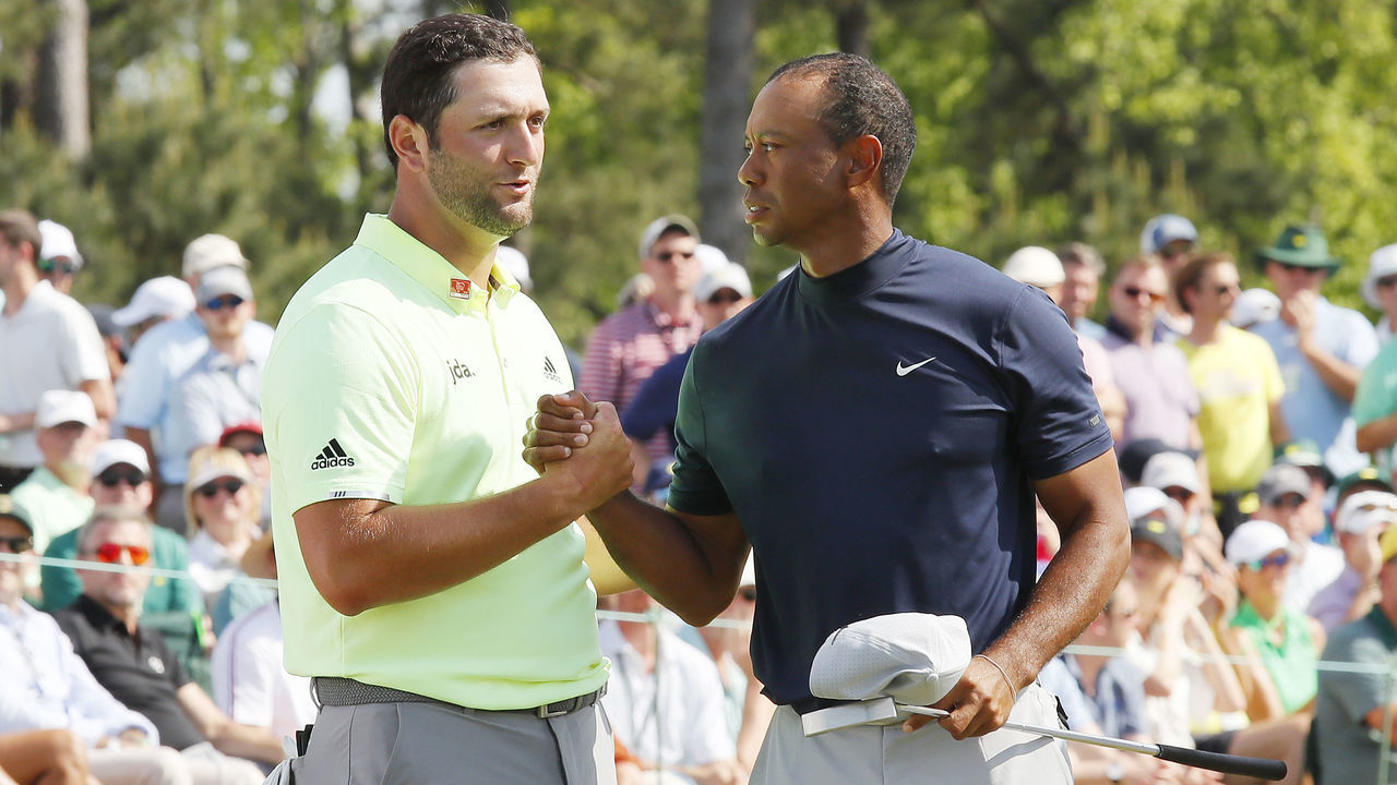 AUGUSTA, GEORGIA - APRIL 11: Jon Rahm of Spain shakes hands with Tiger Woods of the United States on the 18th green during the first round of the Masters at Augusta National Golf Club on April 11, 2019 in Augusta, Georgia.
