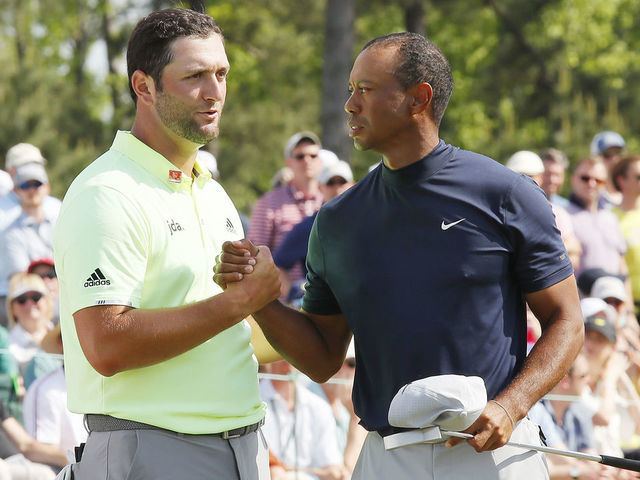 AUGUSTA, GEORGIA - APRIL 11: Jon Rahm of Spain shakes hands with Tiger Woods of the United States on the 18th green during the first round of the Masters at Augusta National Golf Club on April 11, 2019 in Augusta, Georgia.