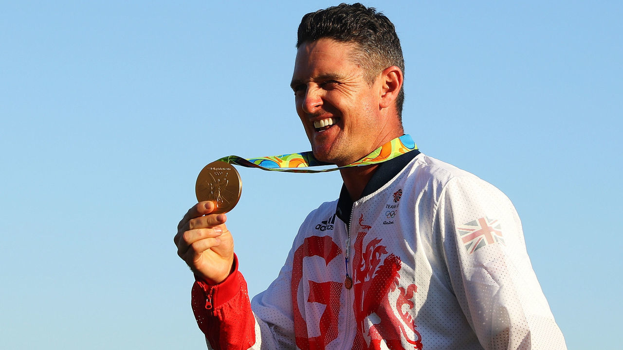 RIO DE JANEIRO, BRAZIL - AUGUST 14: Justin Rose of Great Britain celebrates with the gold medal after winning in the final round of men's golf on Day 9 of the Rio 2016 Olympic Games at the Olympic Golf Course on August 14, 2016 in Rio de Janeiro, Brazil.