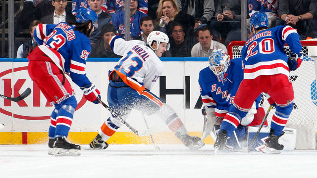 NEW YORK, NY - JANUARY 21: Mathew Barzal #13 of the New York Islanders shoots the puck between his legs against Alexandar Georgiev #40 of the New York Rangers at Madison Square Garden on January 21, 2020 in New York City.