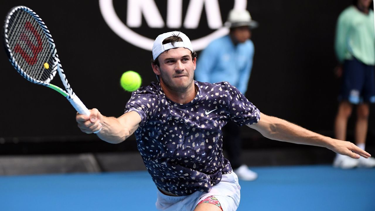 Tommy Paul of the US hits a return against Bulgaria's Grigor Dimitrov during their men's singles match on day three of the Australian Open tennis tournament in Melbourne on January 22, 2020.