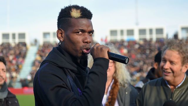 Manchester United and France midfielder Paul Pogba speaks prior to a gala football match between All Star France and Guinea at the Vallee du Cher Stadium in Tours, central France, on December 29, 2019, as part of the "48h for Guinea" charity event.