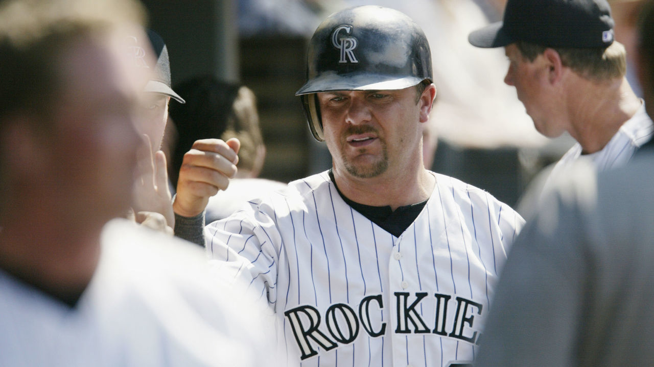 DENVER - JULY 18: Right fielder Larry Walker #33 of the Colorado Rockies receives congratulations from his teammates in the dugout during the MLB game against the Arizona Diamondbacks on July 18, 2002 at Coors Field in Denver, Colorado. The Rockies won 6-4.