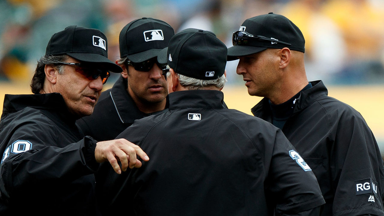 OAKLAND, CA - APRIL 22: MLB umpires Phil Cuzzi #10, Mark Ripperger #90, Vic Carapazza #19 and Tom Hallion #20 discuss a call during the eighth inning between the Oakland Athletics and the Seattle Mariners at the Oakland Coliseum on April 22, 2017 in Oakland, California. The Oakland Athletics defeated the Seattle Mariners 4-3.