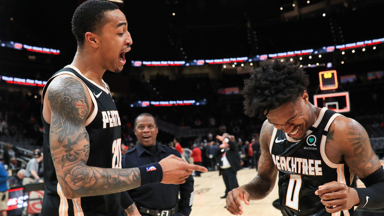ATLANTA, GA - JANUARY 22: John Collins #20 and Brandon Goodwin #0 of the Atlanta Hawks following their 102-95 win over the Los Angeles Clippers at State Farm Arena on January 22, 2020 in Atlanta, Georgia.
